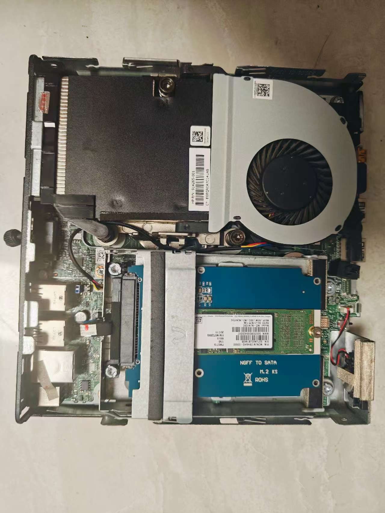 HP ProDesk 400 G3 Mini opened — compact fan, M.2 SSD slot, and DDR4 RAM visible on the motherboard