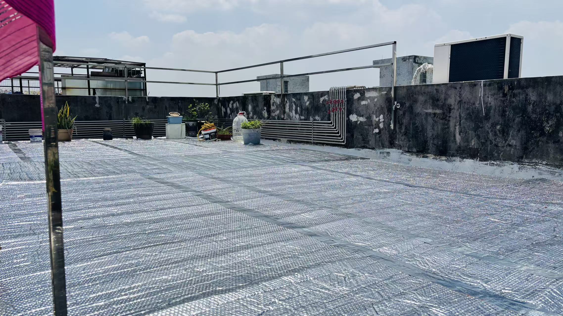 Rooftop completely covered with silver reflective aluminum bubble insulation